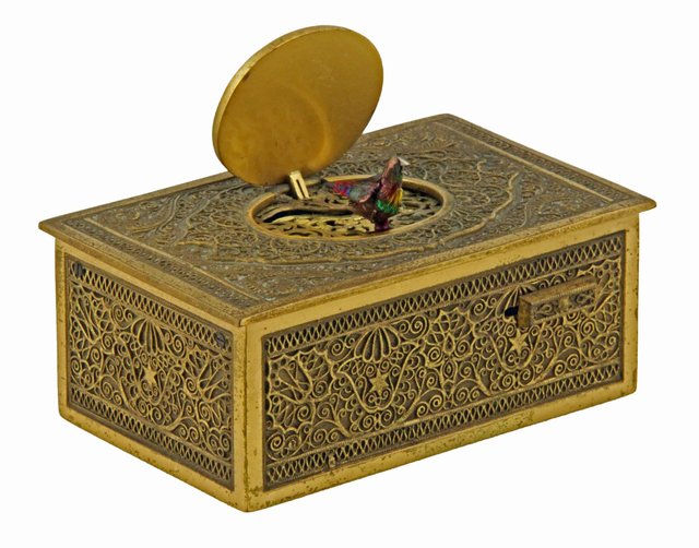 A gilt metal singing bird box with filigree