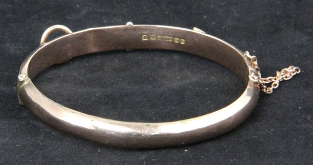 A 9ct gold bangle of belt form with