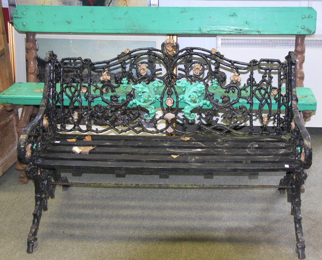 A cast iron garden bench with wooden