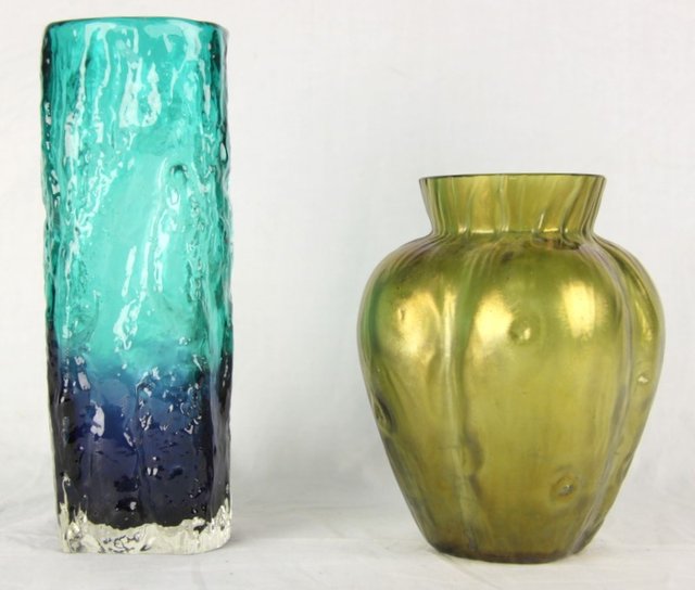 An iridescent green glass vase