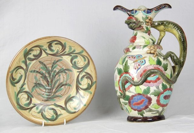 A pottery jug with dragon handle