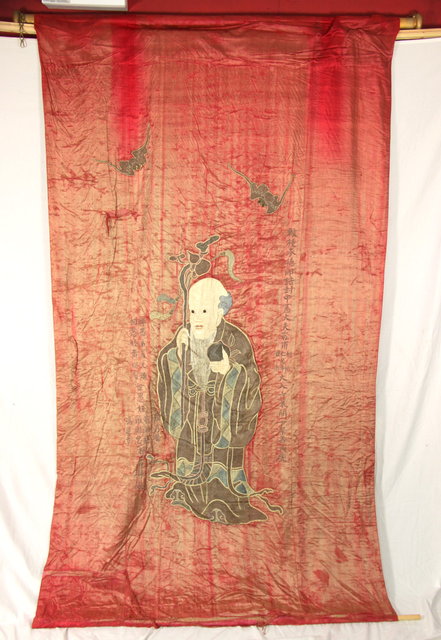 An Oriental wall hanging depicting