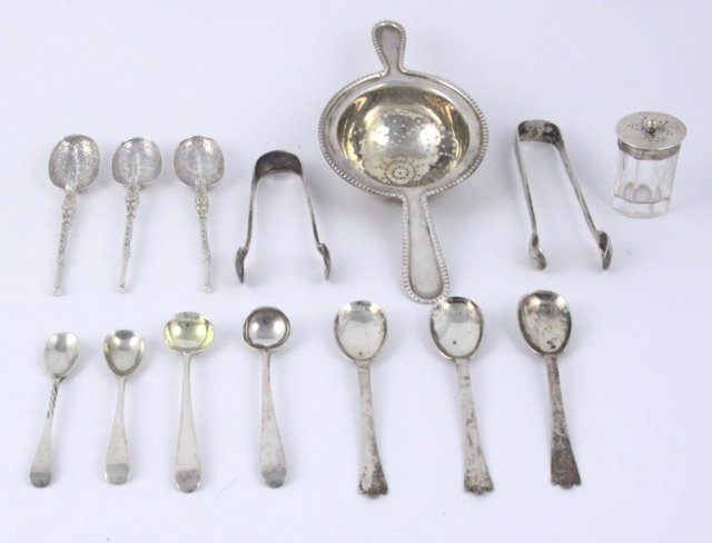 A two-handled silver tea strainer marks