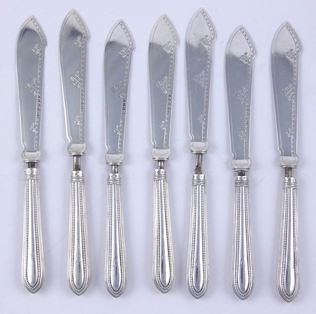 Seven engraved silver fish knives