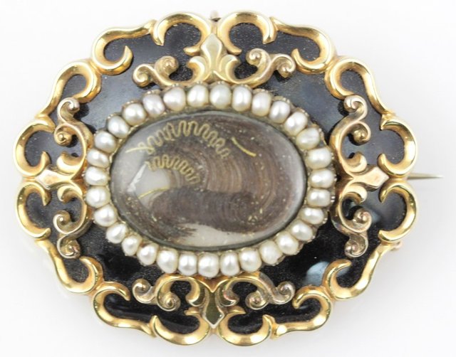 A Victorian mourning brooch centred