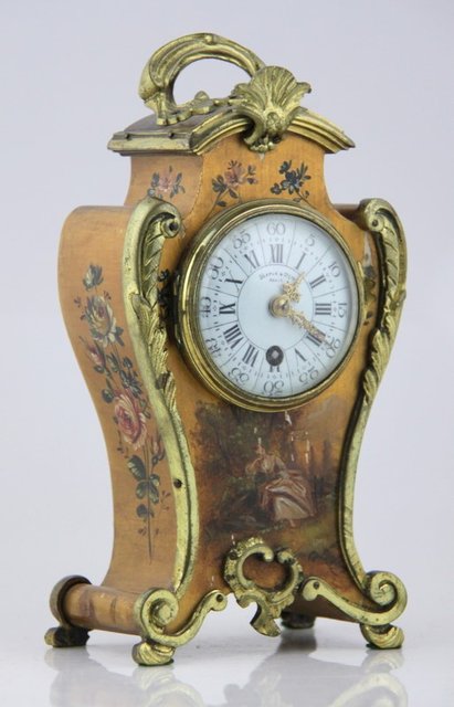 A small French mantel timepiece in a