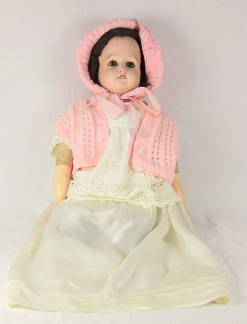 A bisque head doll with brown eyes and