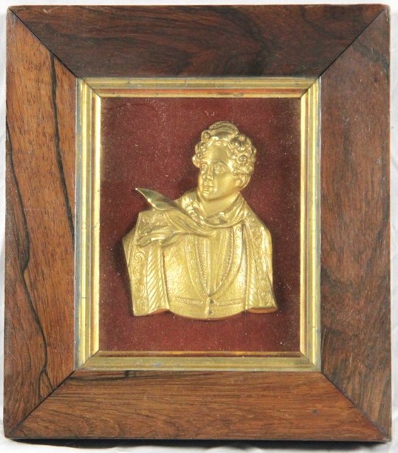 A gilt metal relief half length portrait