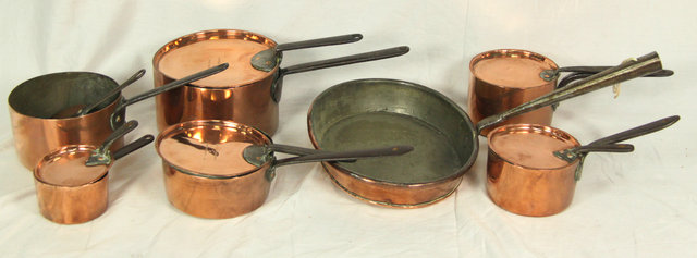 Six copper saucepans with iron handles