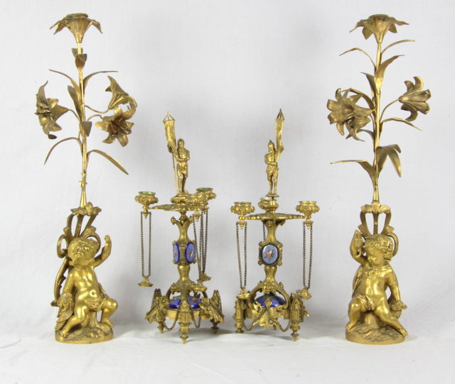 A pair of ormolu putti candlesticks 1655ed