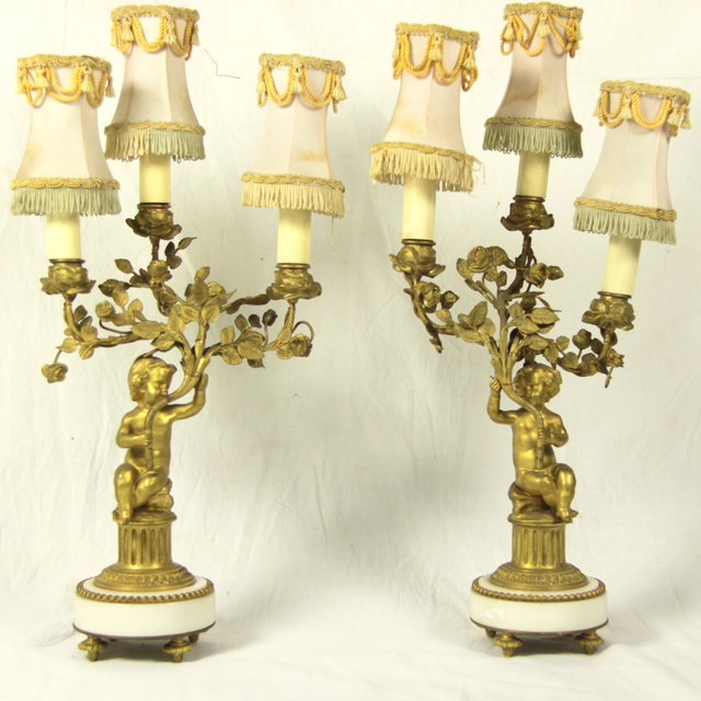 A pair of gilt metal and white