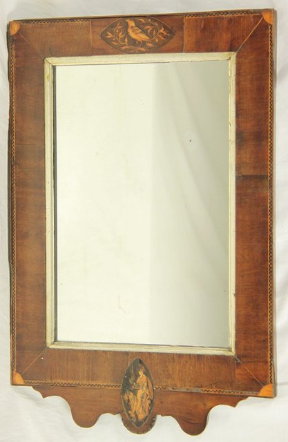 A small wall mirror the frame inlaid
