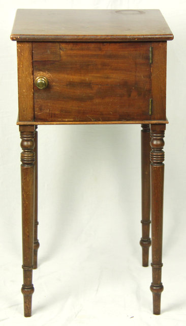 A mahogany bedside cupboard enclosed