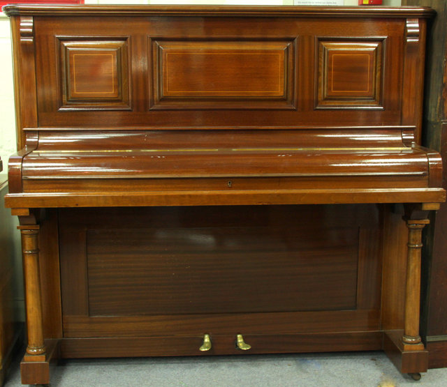 An upright piano in a mahogany case
