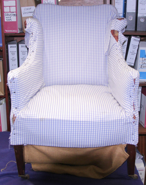 An upholstered armchair on square taper