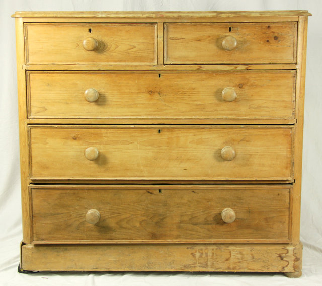 A pine chest of three long and two short