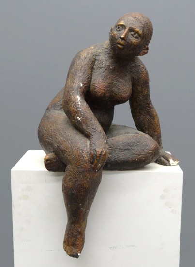 Ceramic sculpture seated woman.
