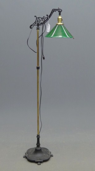 Floor lamp with green glass shade.