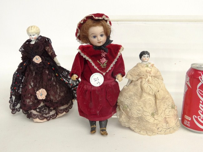 Lot three early porcelain dolls.