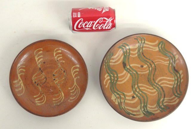 Lot two decorated redware plates