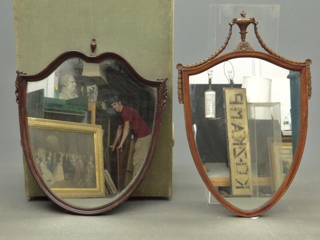 Lot two shield shaped vintage mirrors.