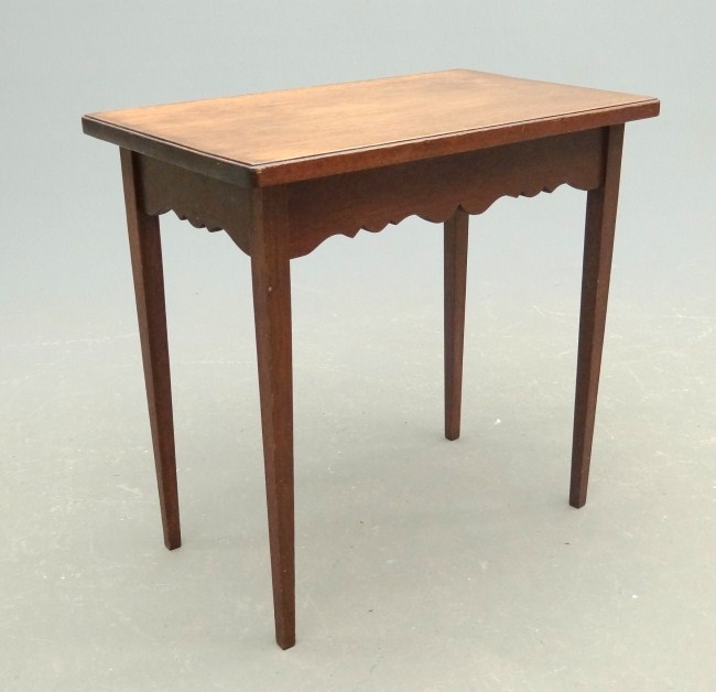 Side table with shaped apron and tapered