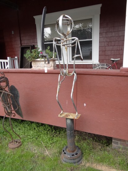 Outdoor sculpture figure with sword.