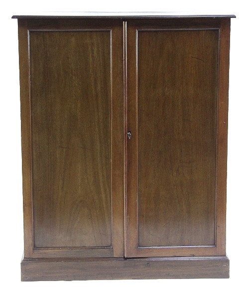 An Edwardian mahogany cupboard enclosed