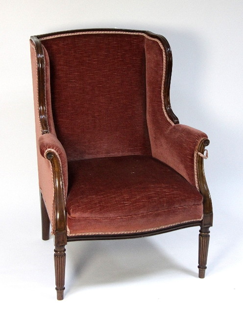 A Louis XV style wing armchair on turned