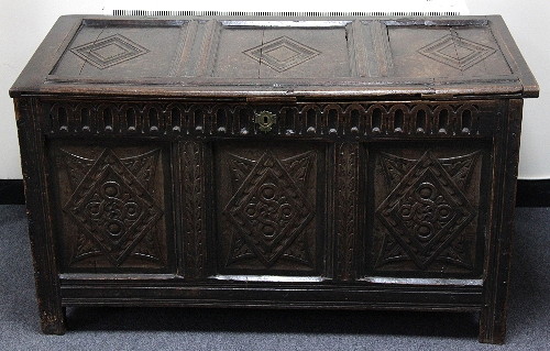 An oak chest the hinged cover carved 168353