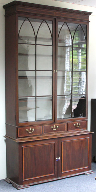 A mahogany display cabinet with pediment