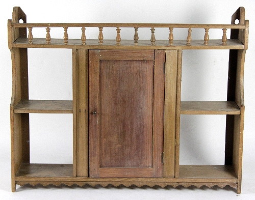 A pine hanging cupboard with galleried