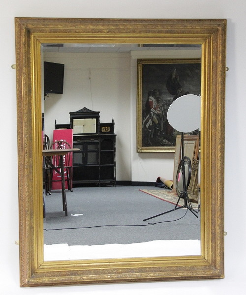 A large bevelled mirror with plaster