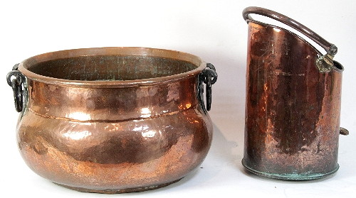 A circular copper cauldron with swing