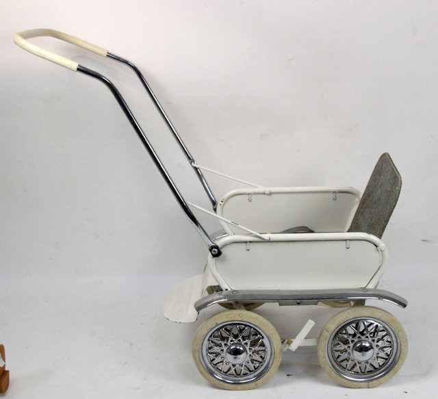 A doll's pram painted white