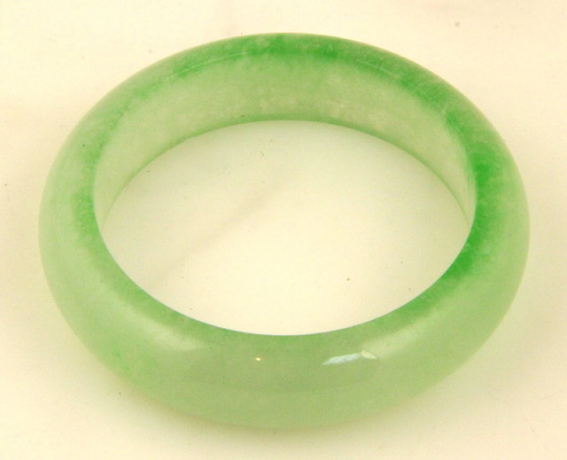 A pale green jade bangle 7.5cm (3)