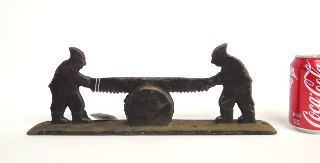 Cast iron bootscraper with men sawing