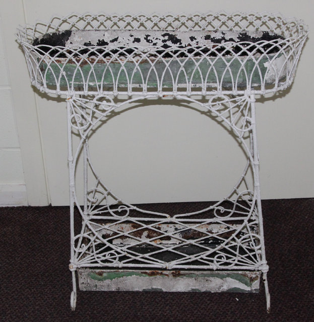 An oval wirework jardini?re stand