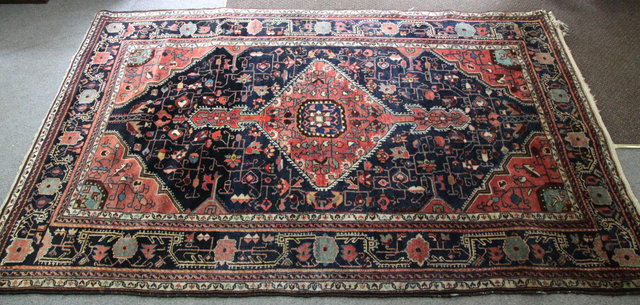 An Oriental rug with single madder