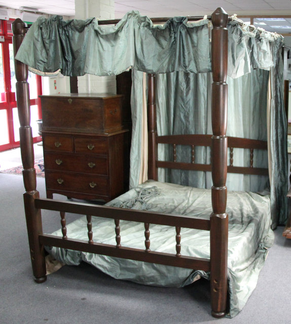 A stained pine four-poster bed with