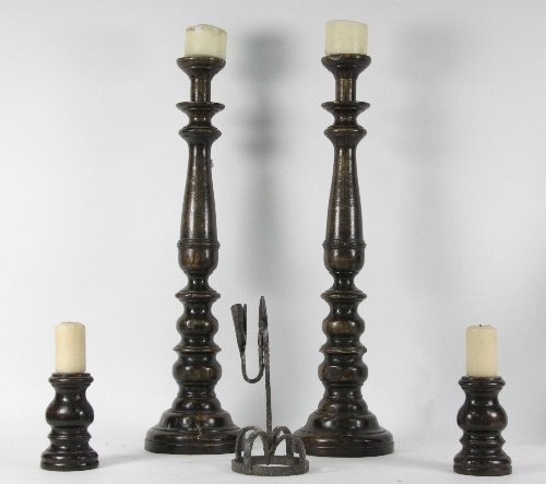 A pair of turned wood candlesticks