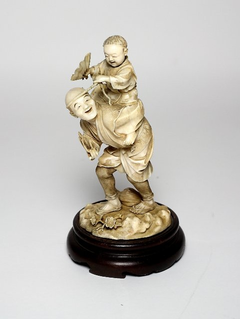 A Japanese carved ivory Okimono