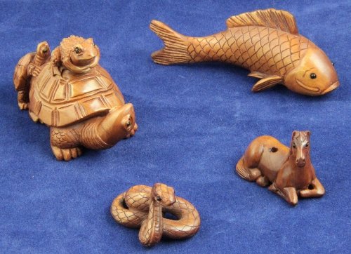 A wooden netsuke signed in the