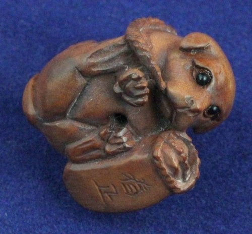 A wooden netsuke signed in the form