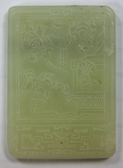 A jade tablet carved with a landscape