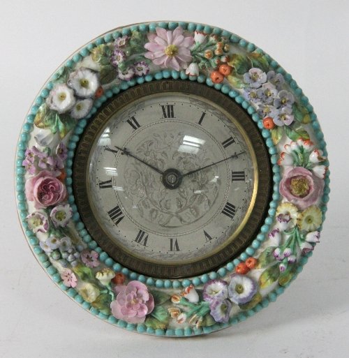 A porcelain mounted easel clock of circular