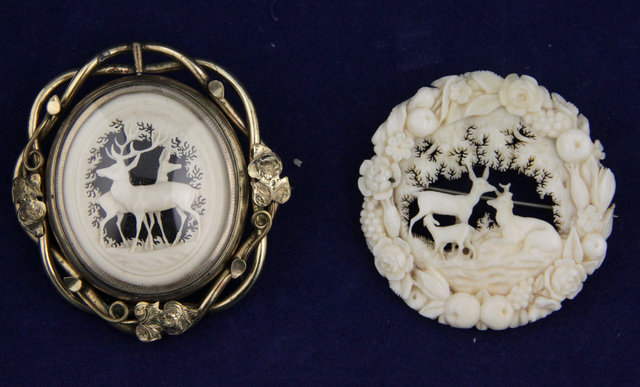 A Victorian carved ivory brooch depicting