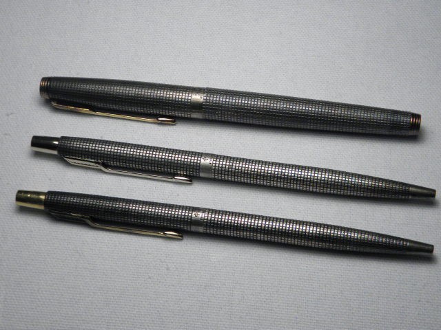 Three Parker ball point pens with