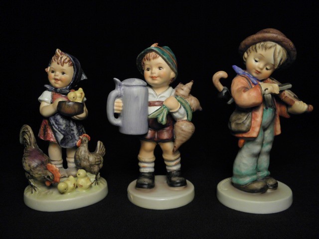 Three Hummel porcelain figurines.