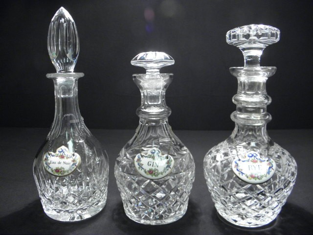 Three cut crystal decanters with